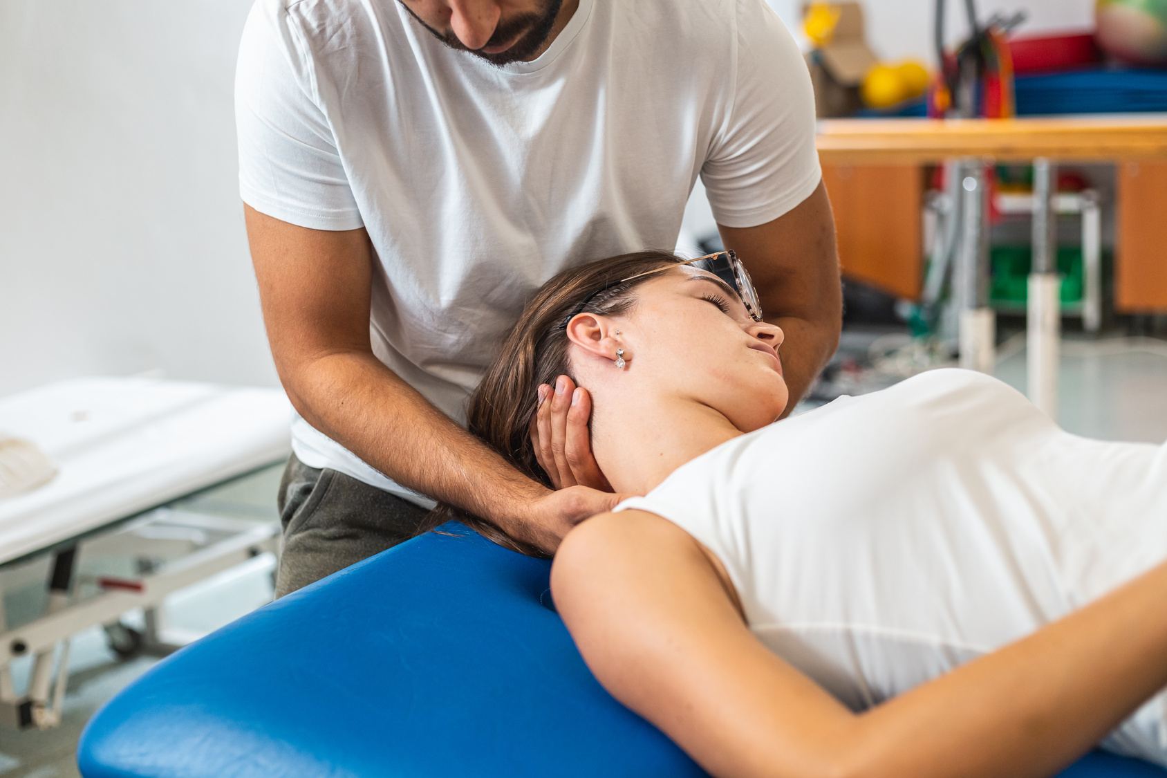 Physiotherapist guiding a patient through a neck stretch